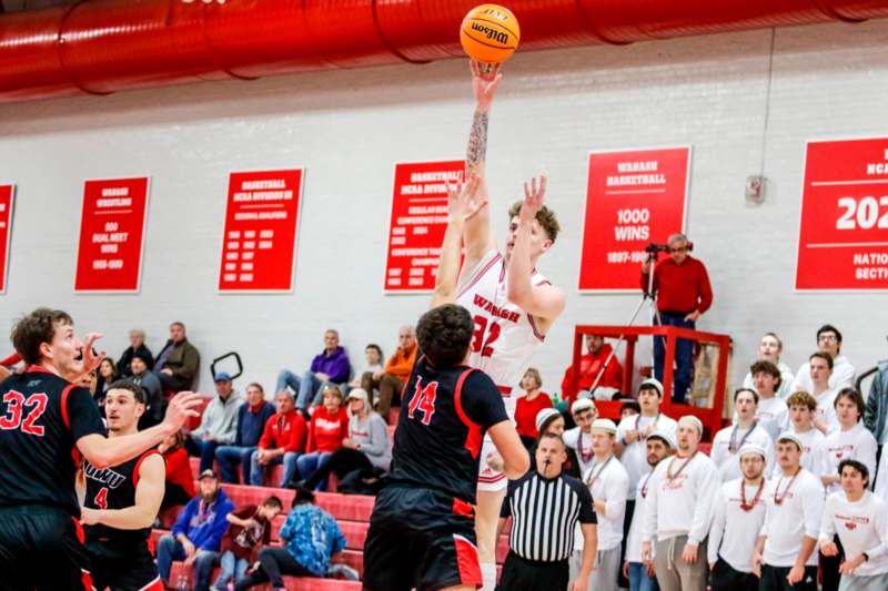 a basketball player jumping to shoot a basketball