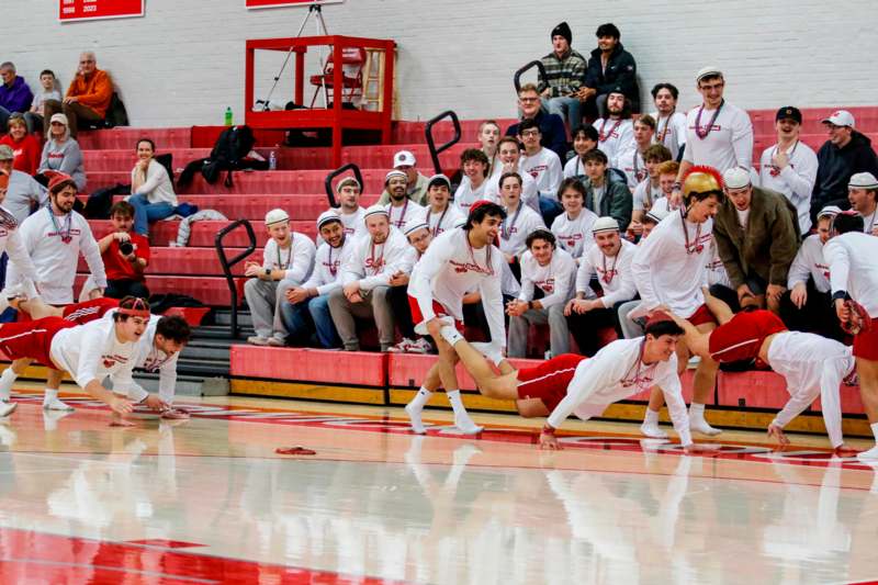 a group of people in white shirts and red shorts in a gym