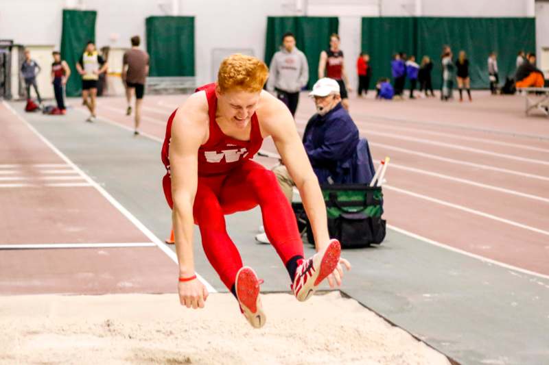 a person jumping over a track