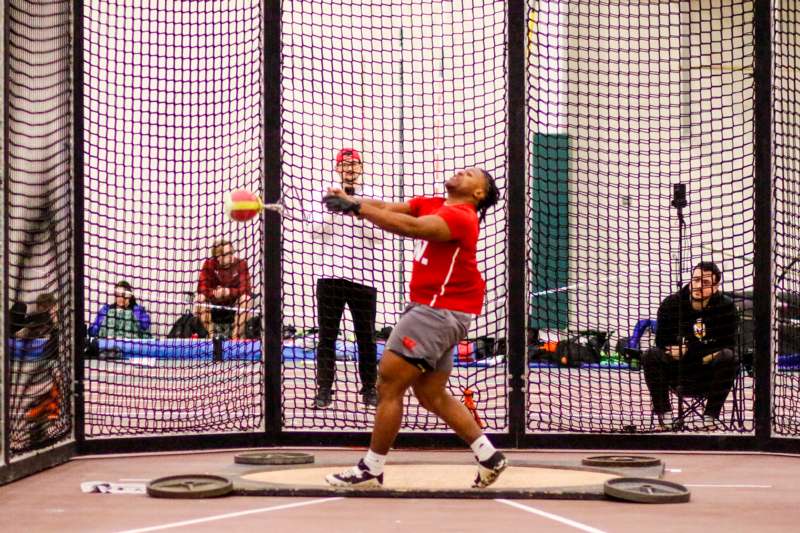 a man hitting a ball with a racket