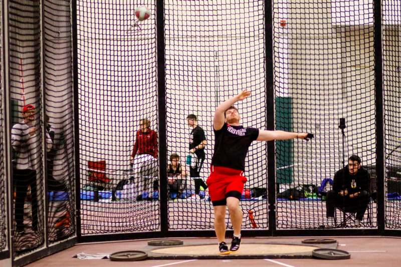 a man throwing a ball in a net