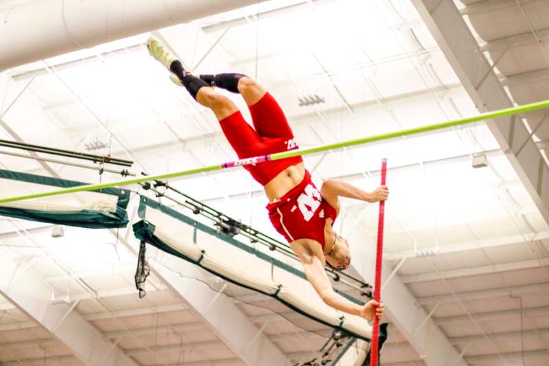 a man jumping over a bar