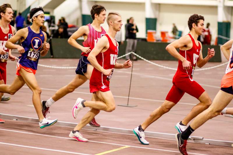 a group of men running on a track