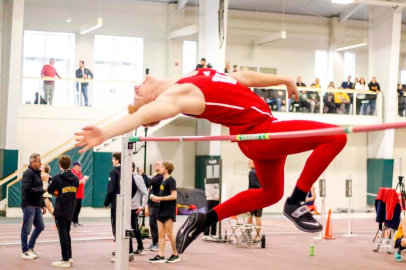 a man jumping over a bar