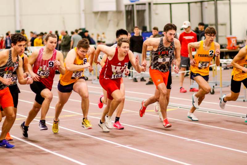 a group of people running on a track