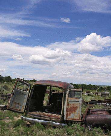an old rusty truck in a field