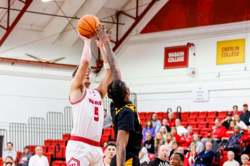 a basketball player reaching for a ball