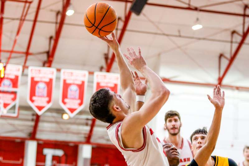 a basketball player reaching for a ball