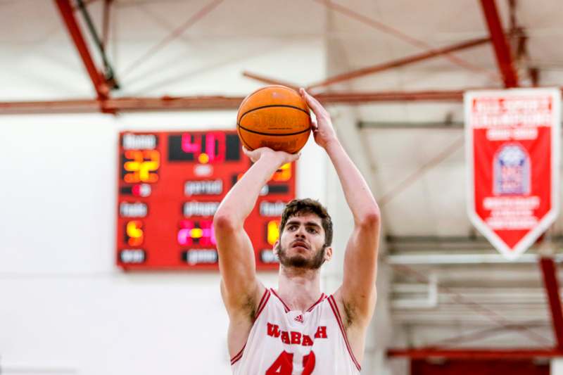 a man in a basketball jersey with a basketball in his hand