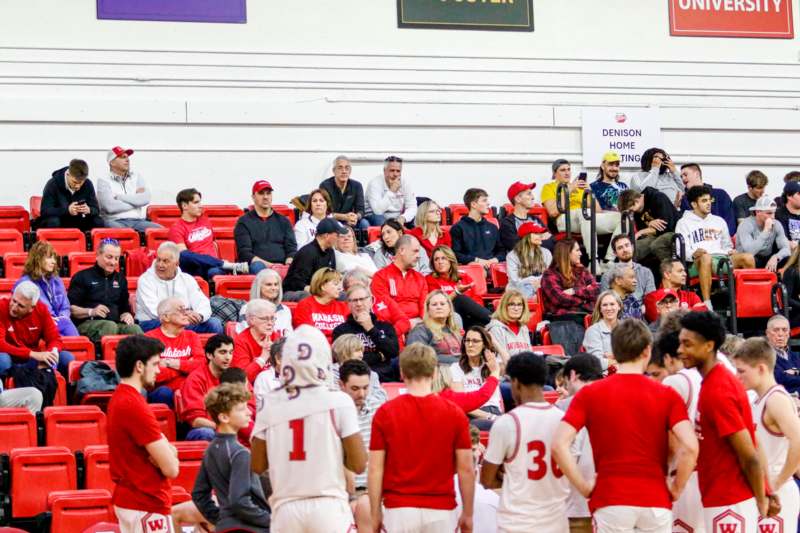 a group of people in red and white sports uniforms in a stadium