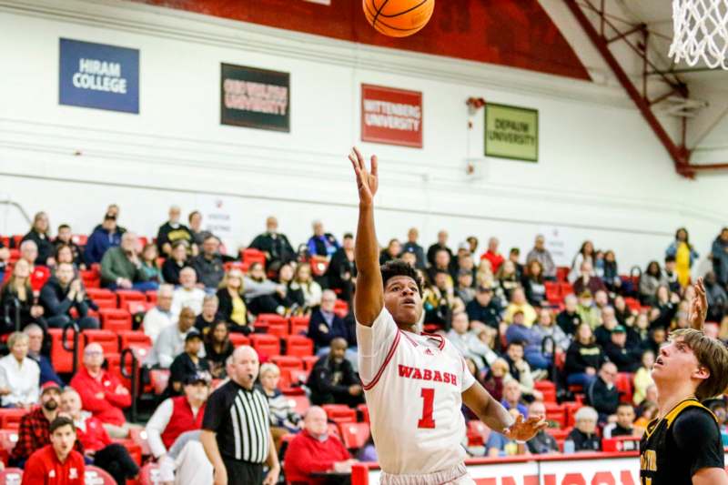 a man in a white uniform jumping to shoot a basketball