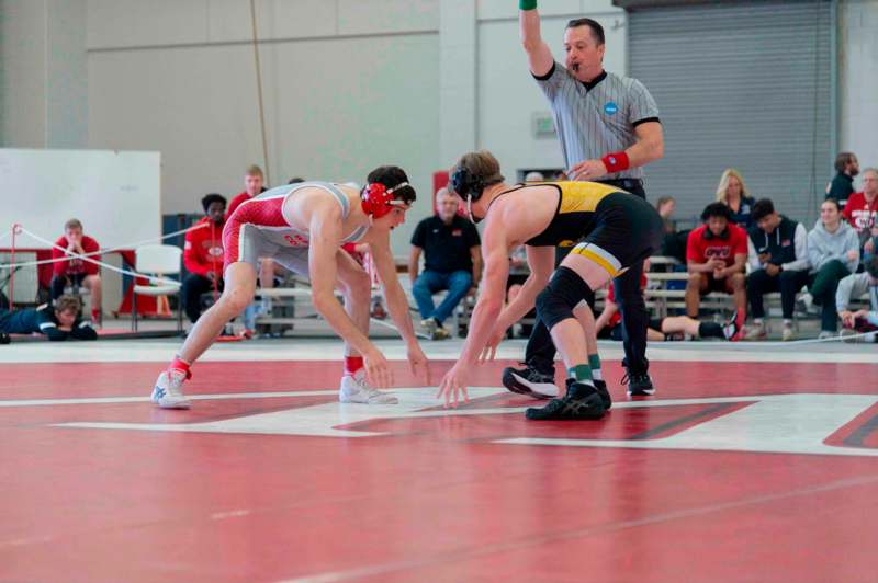 a group of people on a wrestling mat