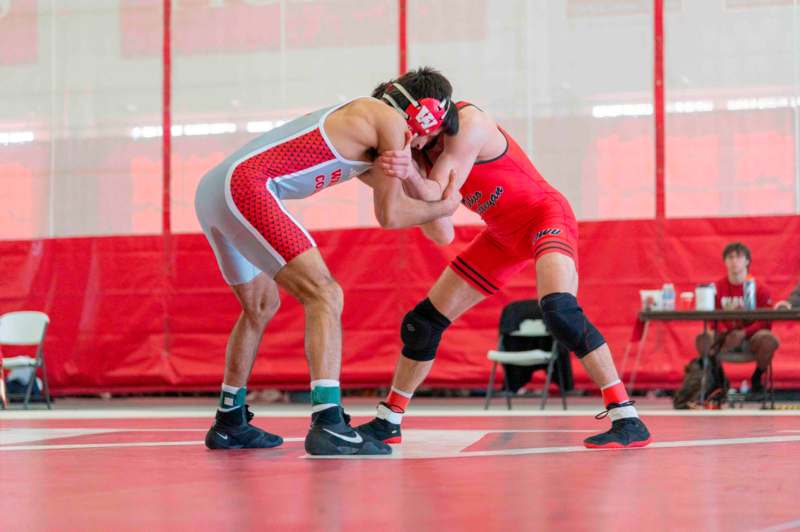 two men wrestling on a mat