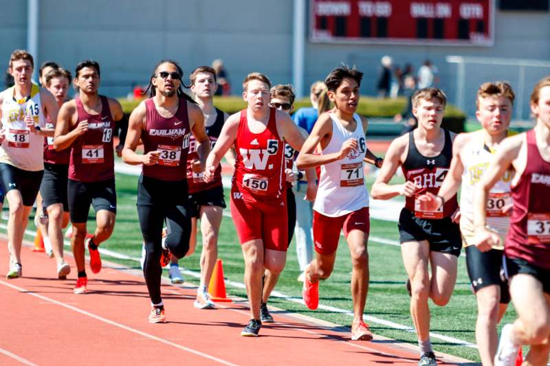 a group of people running on a track