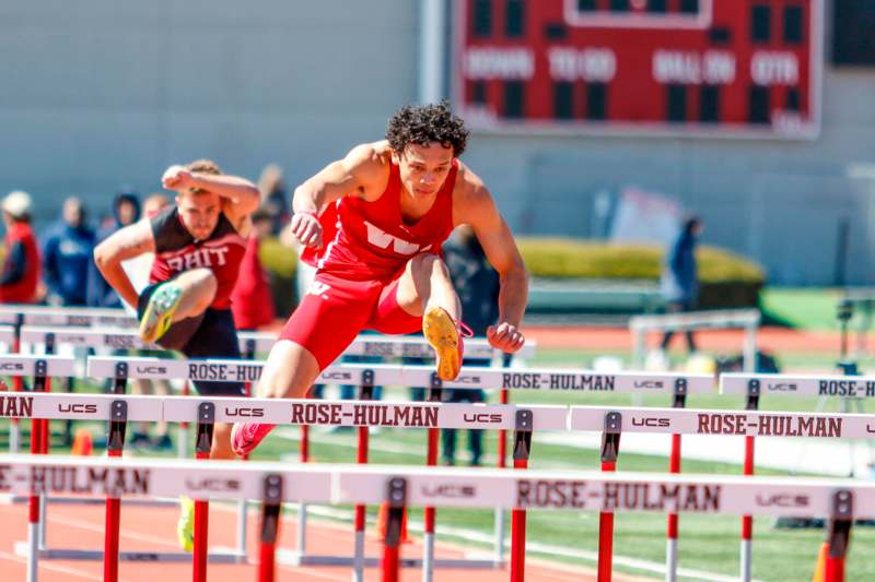 a man jumping over hurdles