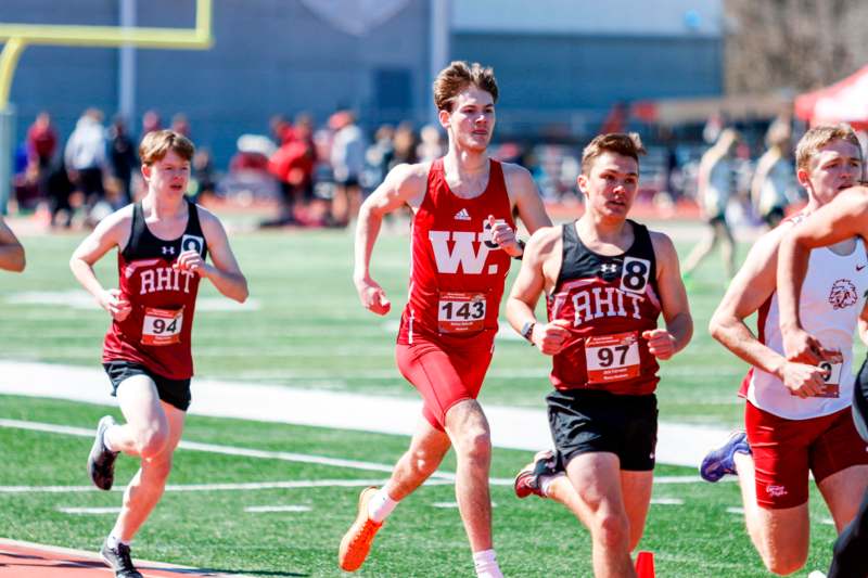 a group of men running on a track