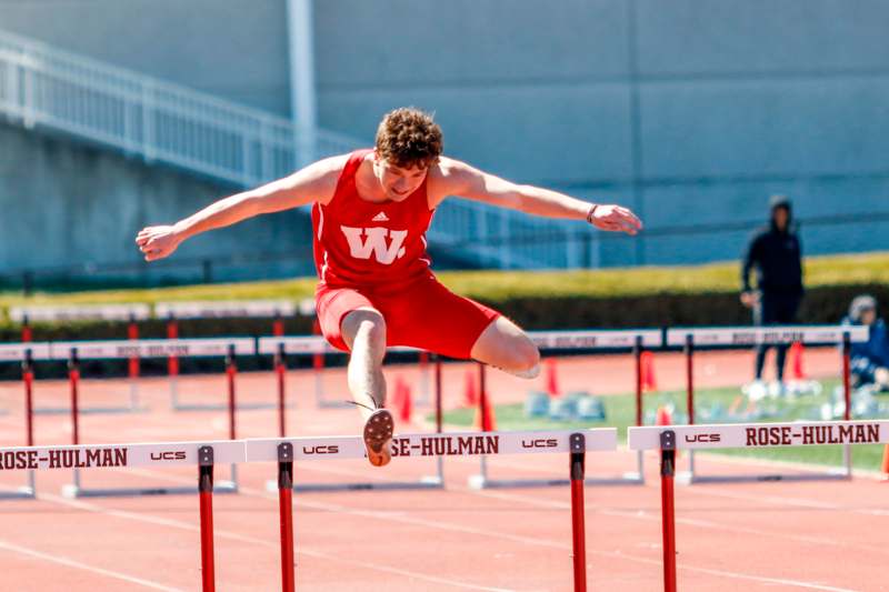 a man jumping over a hurdle