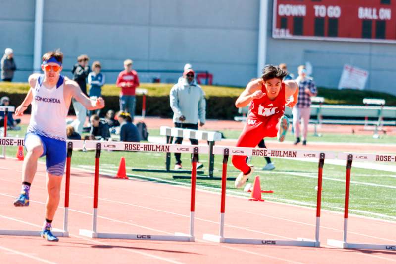 a man in red running on a track