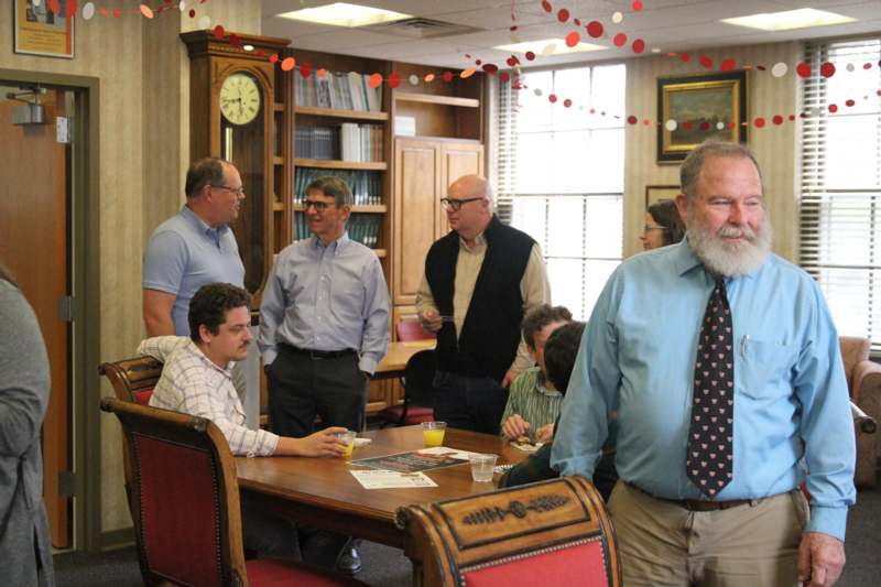 a group of men standing around a table