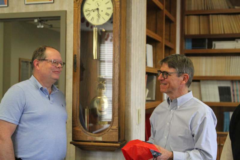 two men standing in a room