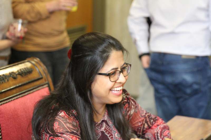 a woman smiling at a table