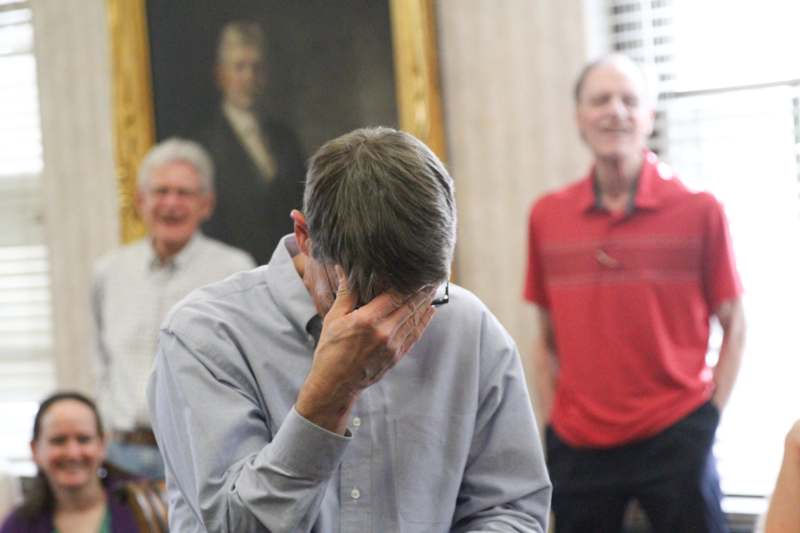 a man holding his head in his hand