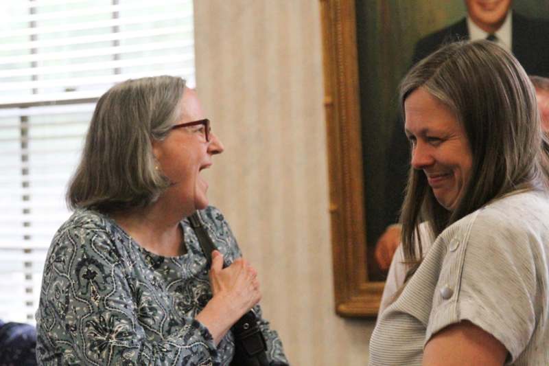 two women laughing at each other
