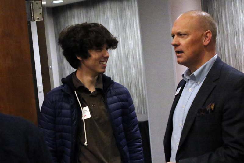 a man talking to a young man