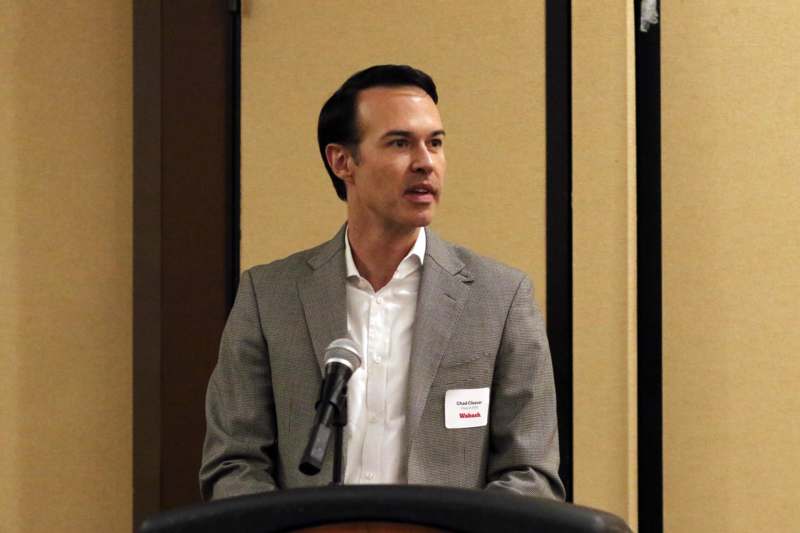 a man standing at a podium with a microphone