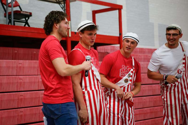 a group of men wearing striped aprons and hats