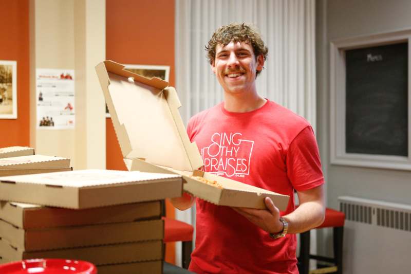 a man holding a pizza box