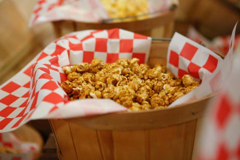 a bucket of popcorn in a red and white checkered paper