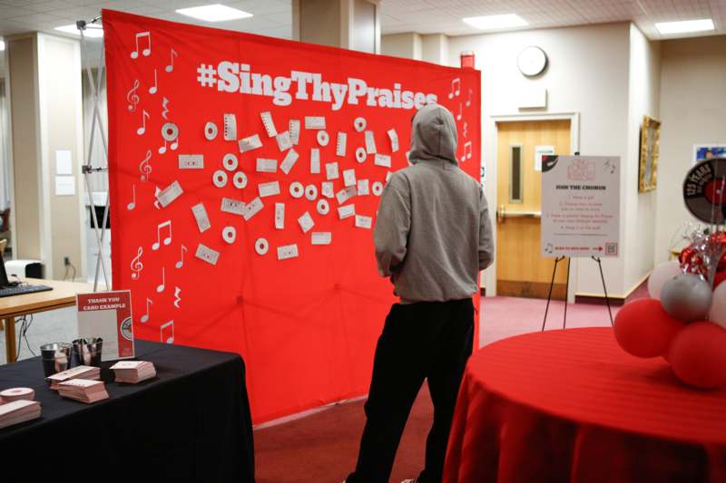 a man standing in front of a red banner