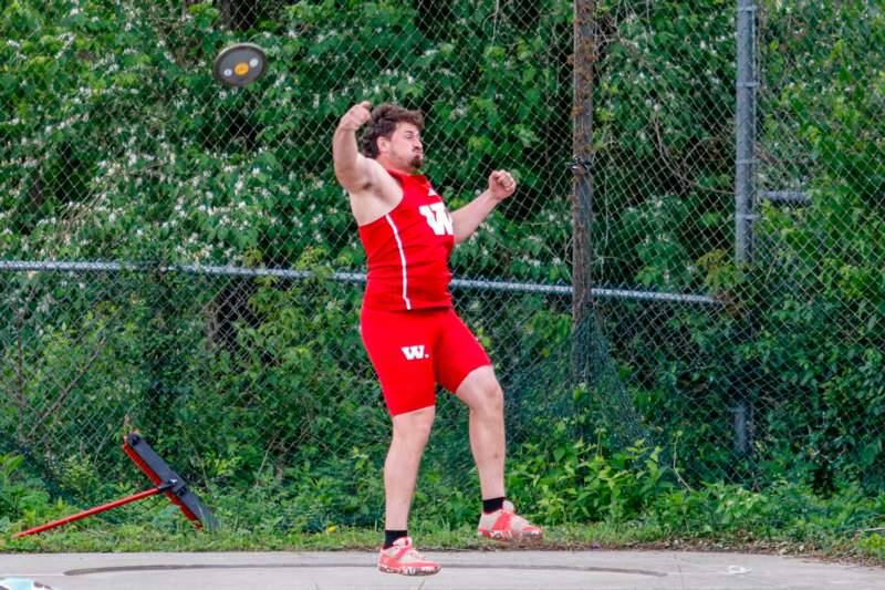 a man in red shorts throwing a disc