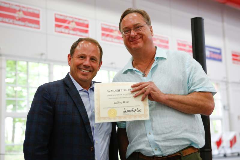 a man holding a certificate