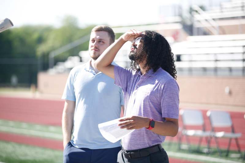 a man standing next to another man