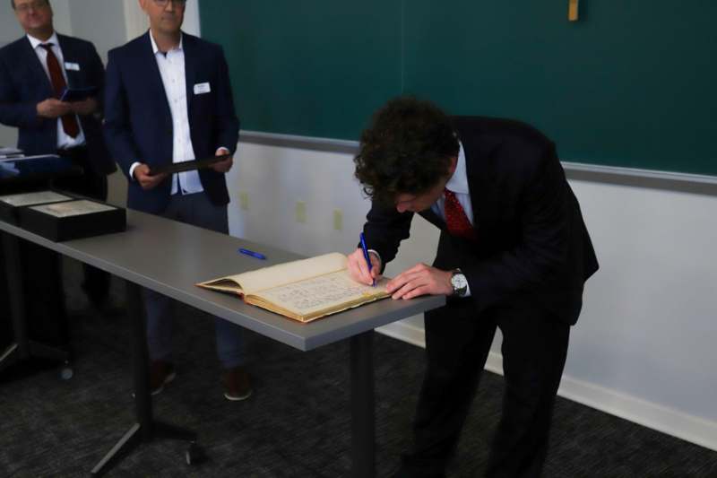 Justin Gineris signs the Phi Beta Kappa book.