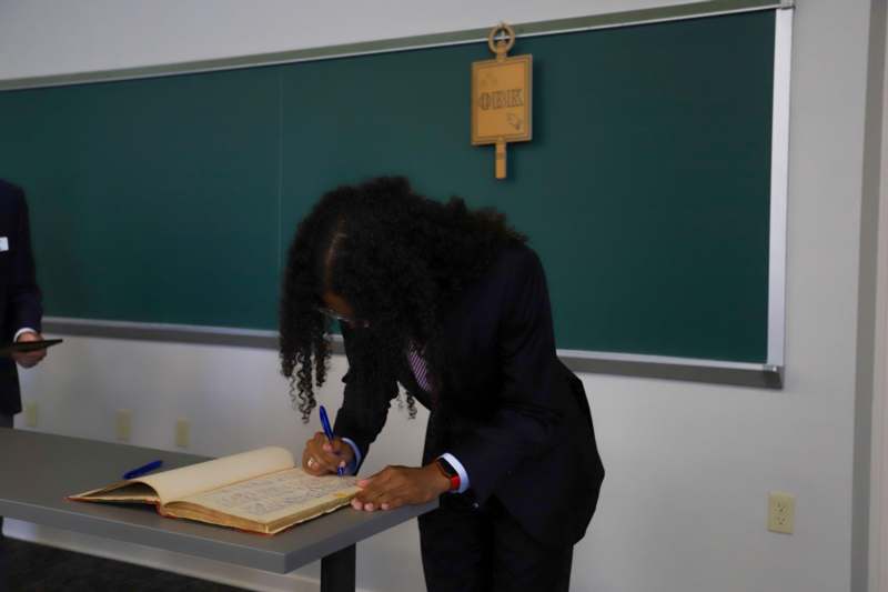 Luis Rivera III signs the Phi Beta Kappa book.