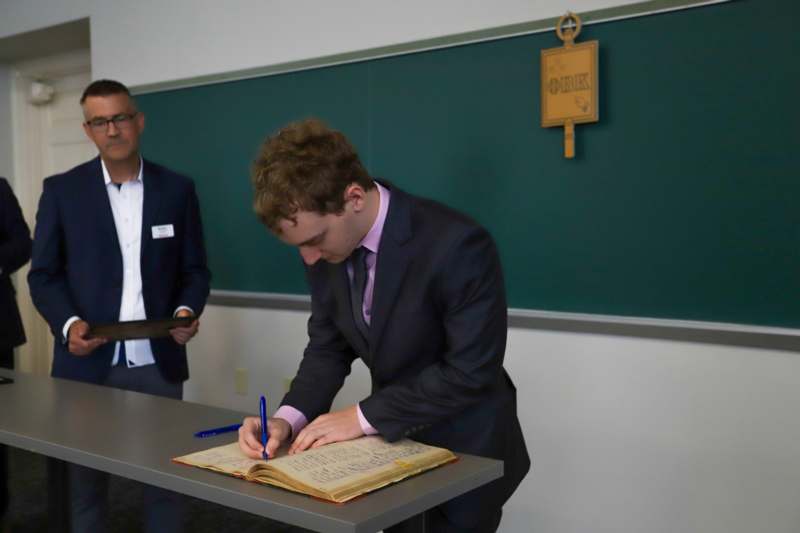 Augustin Sanchez signs the Phi Beta Kappa book.