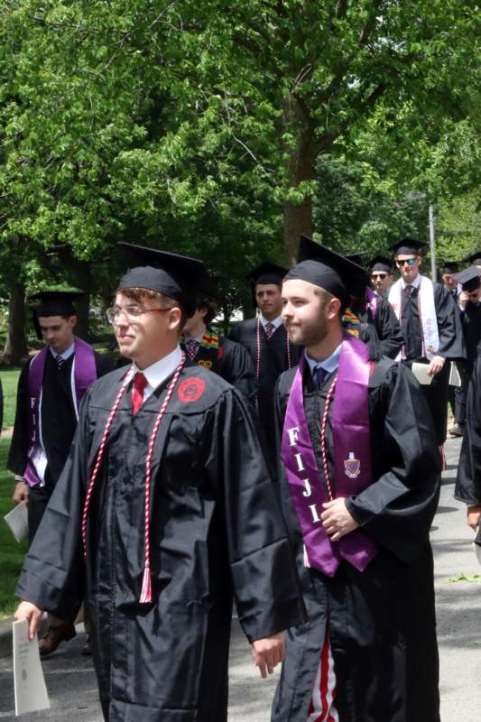 a group of people in graduation gowns and caps