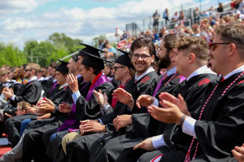 a group of people in graduation gowns and caps