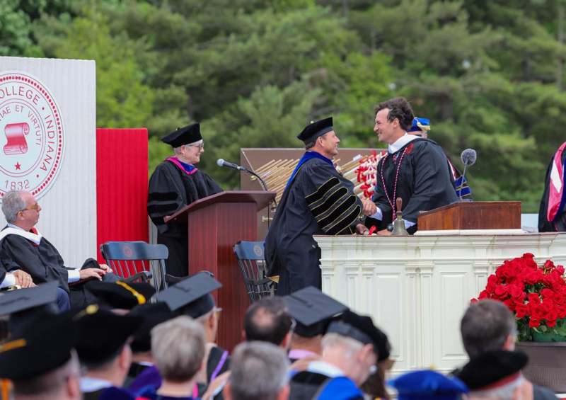 a group of people in graduation gowns and caps
