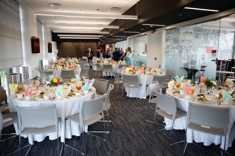 a group of people standing around tables