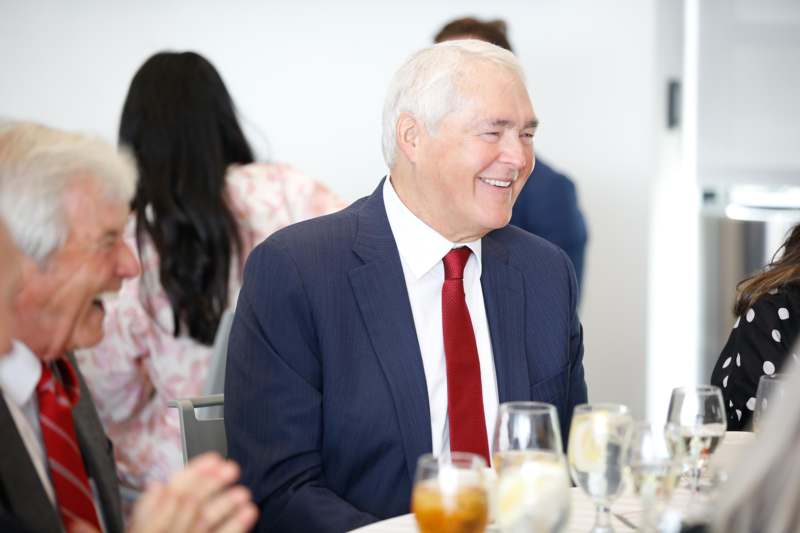 a man in a suit and tie smiling