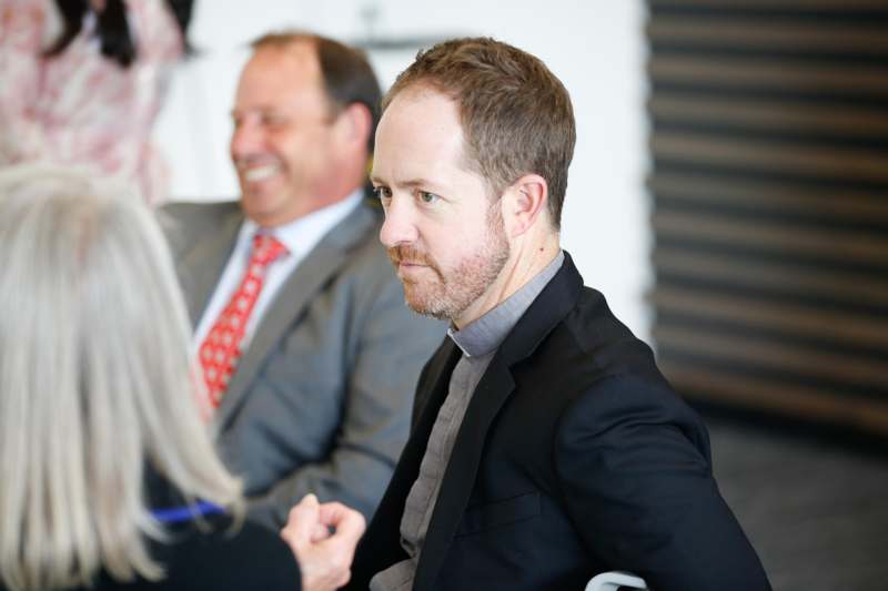 a man in a suit sitting in a chair