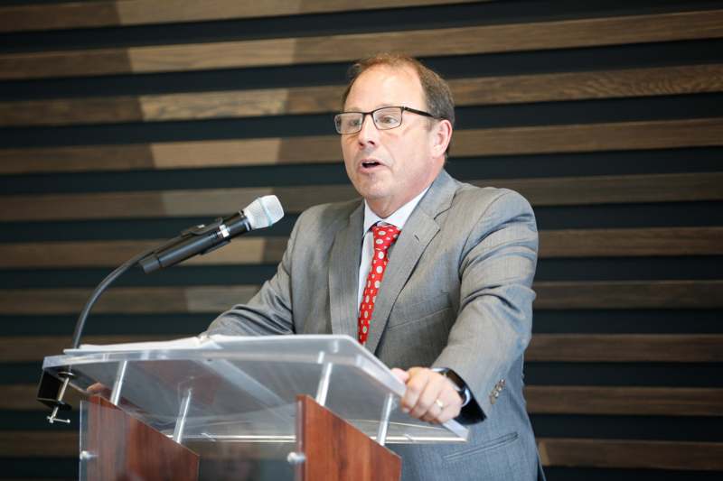 a man standing at a podium with a microphone