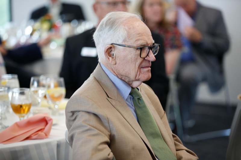 an old man in a suit and glasses