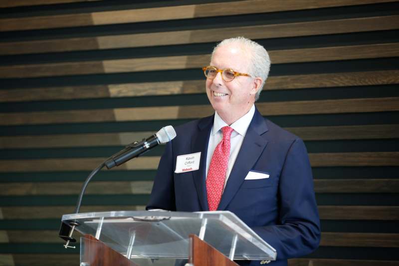 a man standing at a podium with a microphone