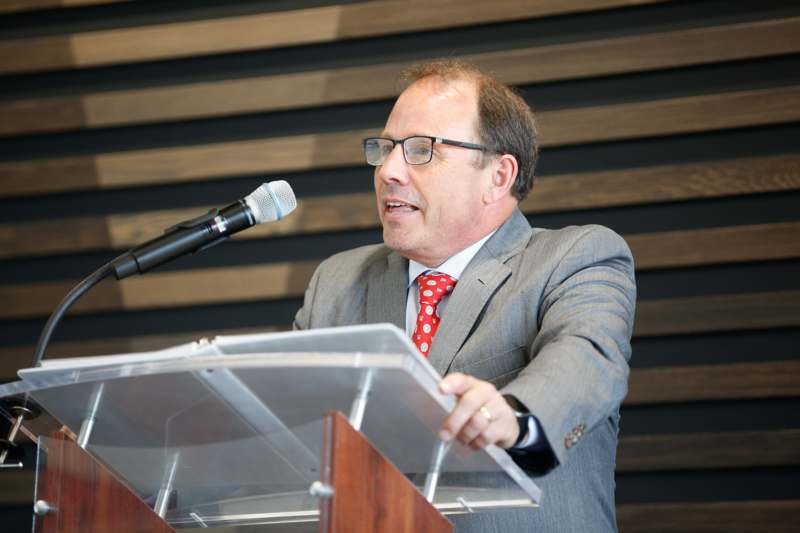 a man standing at a podium with a microphone