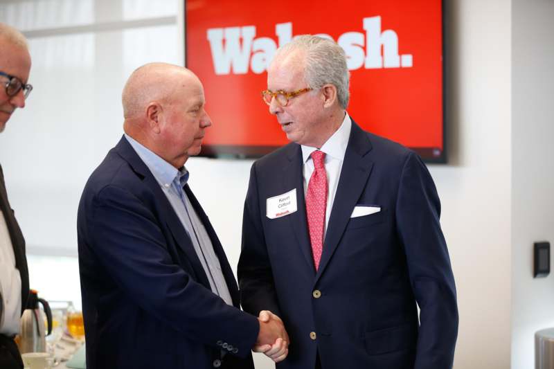 a man shaking hands with another man